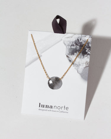 Gem in the Moon Gemstone Necklace- Tourmalinated Quartz displayed on packaging with chain and gemstone.