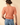 Back view of model wearing orange Round Neck Puff Short Sleeve Cable Sweater with blue jeans