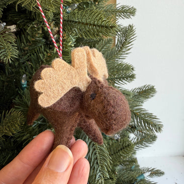 Moose Felt Wool Christmas Ornament held against greenery