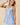 V-neck Baby doll Sleeveless Blouse with Ruffle Top worn by model, showcasing ruffle detail and flowy silhouette.