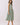 Striped Smocked Waist Round Neck Midi Dress on a model, featuring a relaxed silhouette and side pockets.