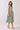 Striped Smocked Waist Round Neck Midi Dress on a model, featuring a relaxed silhouette and side pockets.