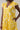 Joni Floral Yodi Shift Mini Dress featuring yellow floral pattern, ruffle sleeves, and tiered skirt with pockets.