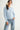 Pearl Button Ribbed Knit Cardigan in light blue shown on a model