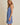 Model wearing SURPLICE S.P.G STRAP FALRE HEM DITSY MINI DRESS in blue floral print, side view.
