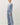 Side view of model wearing blue long sleeve top with matching pants