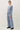 Side view of model wearing blue long sleeve top with matching pants