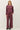 Full-length view of model wearing burgundy sweater with matching pants