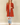 Shop Wall rust orange long sleeve open front cardigan with side pockets worn by a smiling blonde model