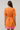 Back view of Donna Dot Elanie Button Down Mini Dress in orange pink with floral pattern and cinched waist design.