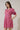 Model wearing Fawna Shift Mini Dress Kendrie Floral with pink and blue floral pattern, split neckline, and puff sleeves.