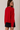 Back view of model wearing red Round Rolled Hemline Detail Thin Sweater Cardigan with black shorts