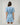 Back view of the Gabriella Denim Fray Mini Dress featuring fringe details and a relaxed fit.