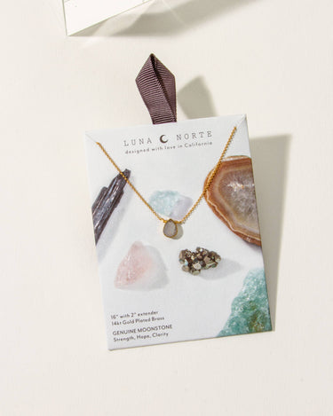 Gold Delicate Gemstone Necklace- Moonstone showcased with gemstones on display card with a ribbon.