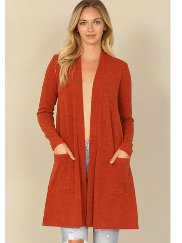 Shop Wall rust orange long sleeve open front cardigan with side pockets worn by a blonde model