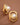 18K Gold Plated Waterproof Stainless Steel Stud Earrings 7652 displayed as a pair on a brown background