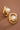 18K Gold Plated Waterproof Stainless Steel Stud Earrings 7652 displayed as a pair on a brown background