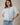 Model wearing light blue short sleeve sweater cardigan