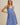 Model wearing SURPLICE S.P.G STRAP FALRE HEM DITSY MINI DRESS in blue floral print, perfect for casual outings.