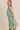 Model wearing BOAT NECK SLEEVELESS SIDE TIES MINI DRESS in green and white stripes.