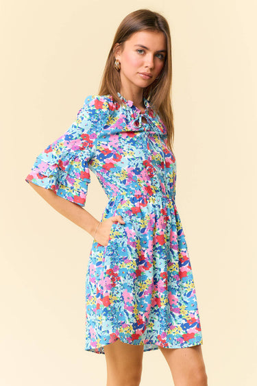 Floral Printed Split V-Neck Half Bell Sleeve Dress showcased on a model with floral designs and ruffle details.