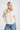Model wearing COLLARED V NECK BUTTON DOWN LINE LACE SHIRT with a button-down front and short sleeves.