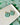 Two Tone Shamrock Earrings Clover Clay Earrings displayed on a plate with a green clover background.