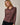 Model wearing burgundy Mock Neck Long Sleeve Button Up Top with black pants