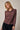 Model wearing burgundy Mock Neck Long Sleeve Button Up Top with black pants