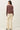 Back view of model wearing dusty mauve Ultra Soft Boatneck Basic Long Sleeve Top with cream pants