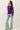 Side view of model wearing purple Ultra Soft Boatneck Basic Long Sleeve Top with blue jeans