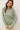 Model wearing sage green raglan sleeve slub pullover sweater, front view