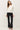 Front view of model wearing white long sleeve top with black pants