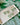 Clover Bow Earrings Shamrock Bow Earrings Lucky Bow displayed on a plate with a green shamrock background.