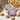 Organic Love Purple Handmade Soap displayed in a wooden basket with seashells and coral.