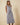 Blue striped V neck cap sleeve button up waist tie belt midi dress worn by a model, full-body view.