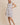 ROUND NECK RUFFLE SHORT SLEEVE FLORAL PRINT DRESS modeled by a model wearing a size small.