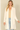 Shop Wall open front cardigan in cream with long sleeves and side pockets worn by a blonde model