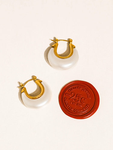 Roselle 18K Gold Non-Tarnish Teardrop Hoop Earrings displayed with a vintage 25 cent token.