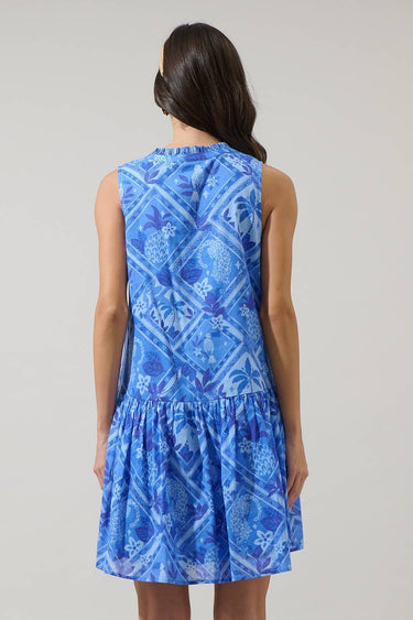 Model wearing the Kaidy Tropical Loly Trapeze Mini Dress in blue, showing the back and ruffle detail.
