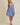 Model wearing SURPLICE S.P.G STRAP FALRE HEM DITSY MINI DRESS in blue floral print.
