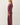 Side view of model wearing burgundy sweater with matching pants