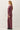 Side view of model wearing burgundy sweater with matching pants