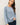 Model wearing blue raglan sleeve slub pullover sweater, front view