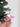 Pink felt flying pig keychain displayed with green foliage