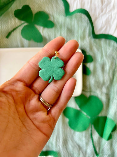 Four Leaf Clover Earrings Shamrock Earrings displayed in a hand, showcasing the green polymer clay design.