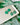 Shamrock Earrings Clover Clay Earrings Clover Earrings displayed on a ceramic plate with green clover background.