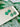 Shamrock Earrings Clover Clay Earrings Clover Earrings displayed on a ceramic plate with green clover background.