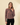 Shop Wall brown and white striped knit long-sleeve button-up cardigan worn by a model
