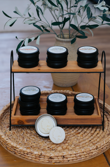 Coconut Lime Beeswax Lotion Bars arranged with essential oils